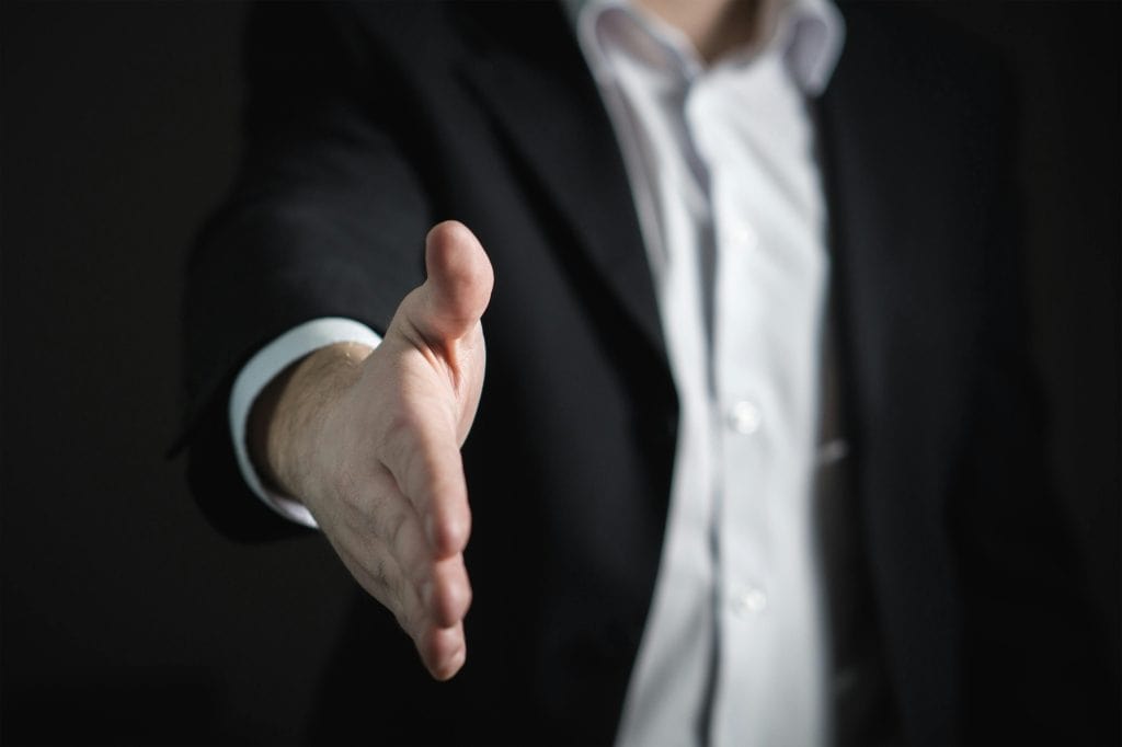 Close-up of human hand offering handshake
