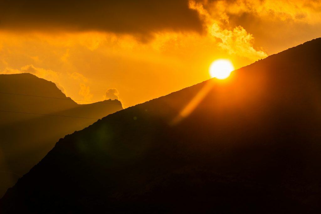 Sunset/sunrise silhouette of a mountain.